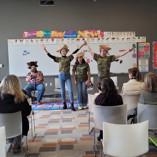 The Dallas Opera Cummity Performance - actors singing in front of a classroom white board